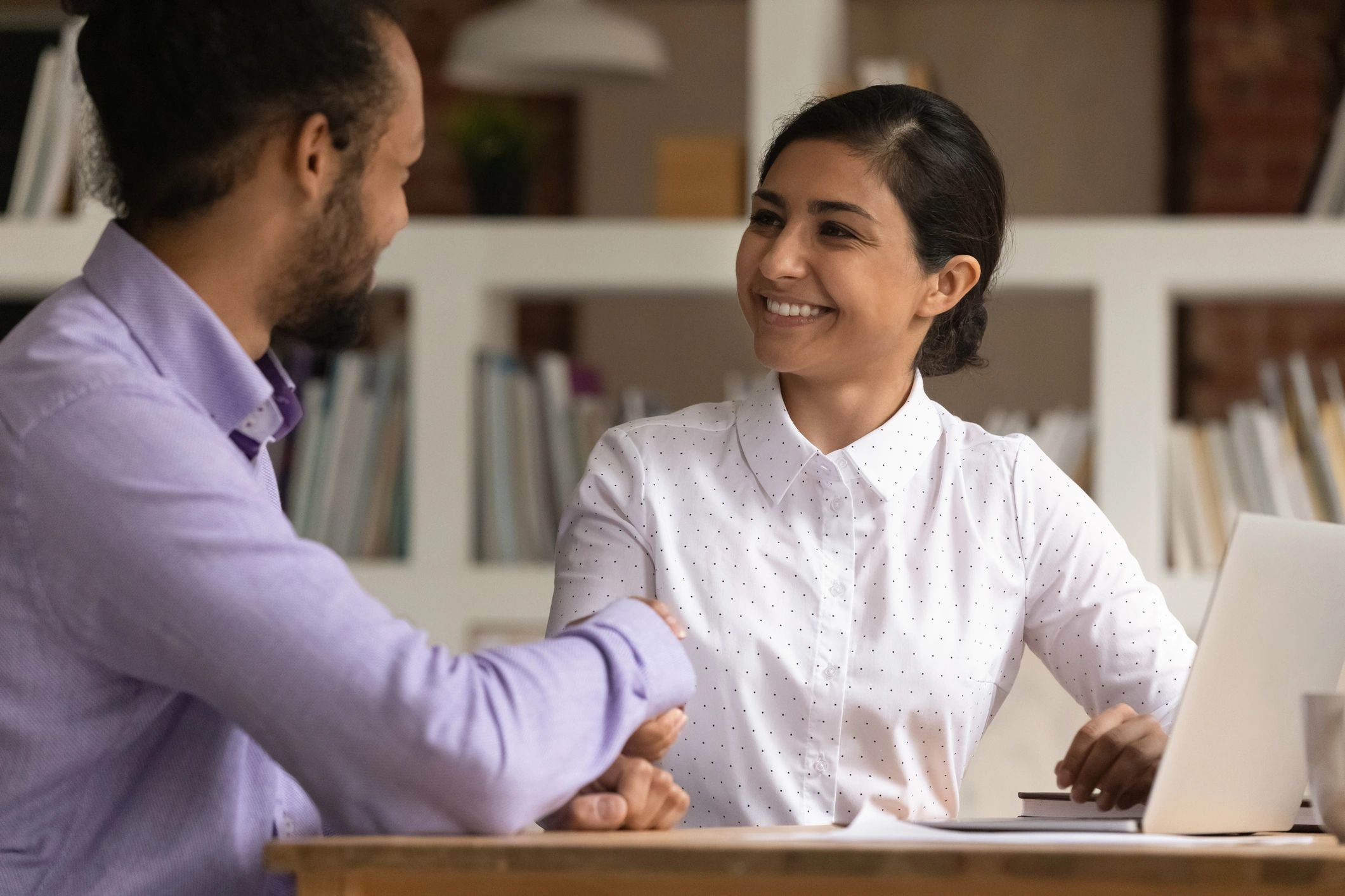 Candidate and HR manager shaking hands after an interview